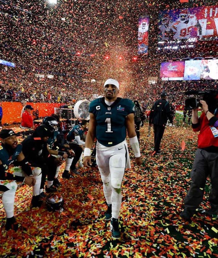 a football player walking through confetti on the field