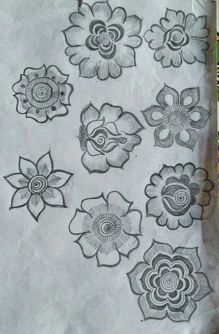 some flowers are drawn on a piece of paper