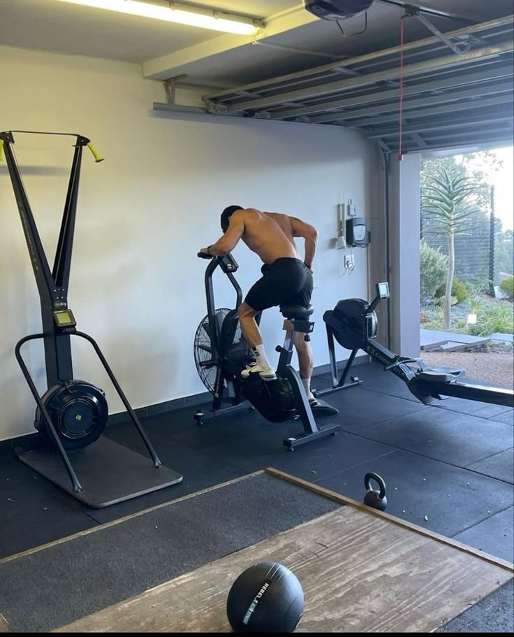 a man on a stationary bike in a gym