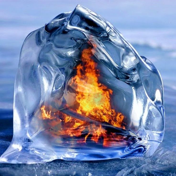 an ice cube with fire in it on the water