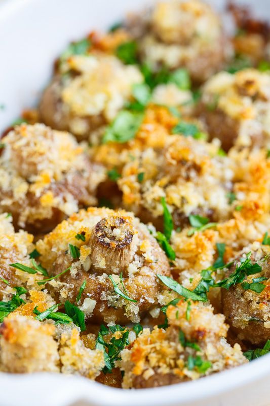 a casserole dish filled with meatballs and garnished with parsley