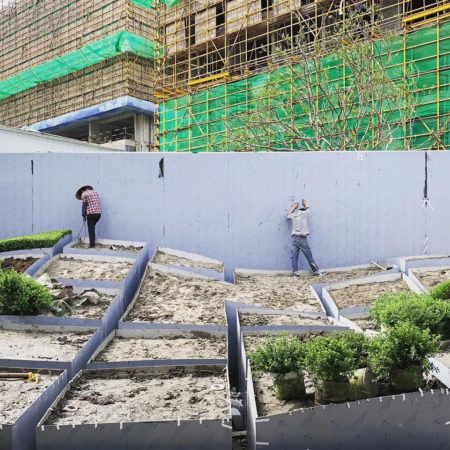 two men working on the side of a building under construction