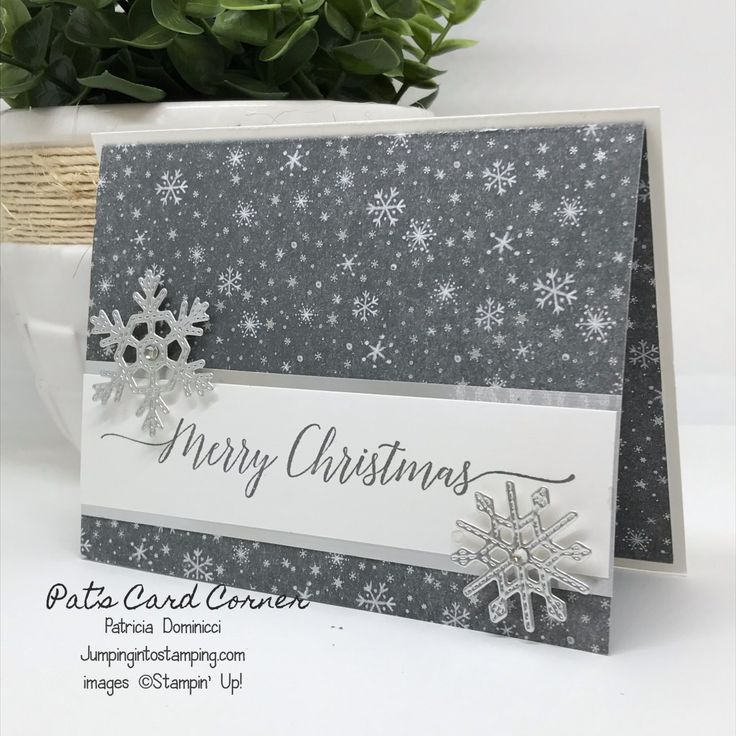 a christmas card with snowflakes on it and the words merry christmas written in silver