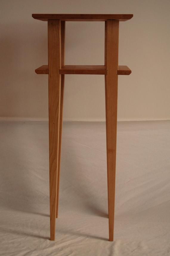 a small wooden table with two legs on it