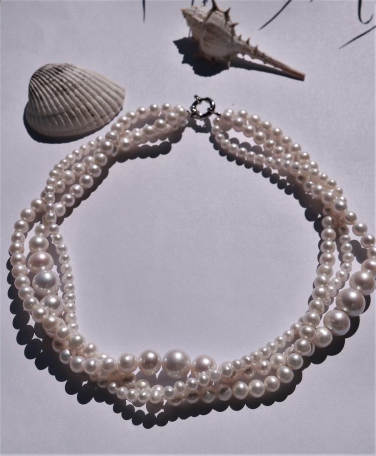 Enhance your fashion sense with our stunning Triple Twisted Pearl Choker Necklace, an exquisite jewelry piece meticulously made from natural freshwater round pearls, forming an alluring statement necklace. An ideal selection for a meaningful gift, suitable for various celebrations like birthdays, anniversaries, weddings, summer events, or any special occasion. Crafted to complement a bridal gown or elevate a relaxed summer look, this distinctive necklace features three rows of radiant round fres Multi-strand Pearl White Necklace With Pearl Pendant, Formal Multi-strand Pearl Necklace With Charm, Pearl White Multi-strand Necklace With Pearl Pendant, Classic Multi-strand Pearl Necklace For Wedding, Elegant Multi-strand Pearl Necklace With Charm, Baroque Pearl Necklace With Pearl Charm, Formal Multi-strand Pearl Necklace, Multi-strand Pearl Necklace For Wedding, Classic Multi-strand Pearl Necklace With Charm