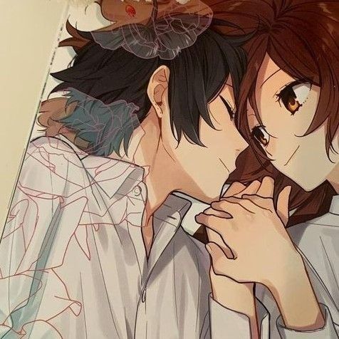 two anime characters are kissing each other in front of a flowered wall hanging from the ceiling