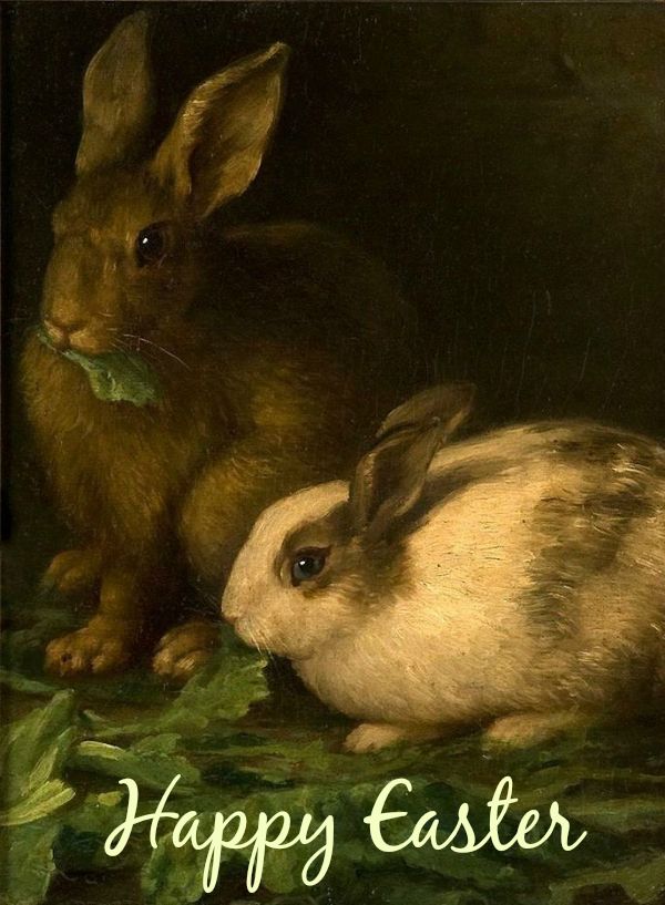 two rabbits sitting next to each other on green leaves