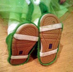 a pair of slippers sitting on top of a wooden floor next to a plastic bag