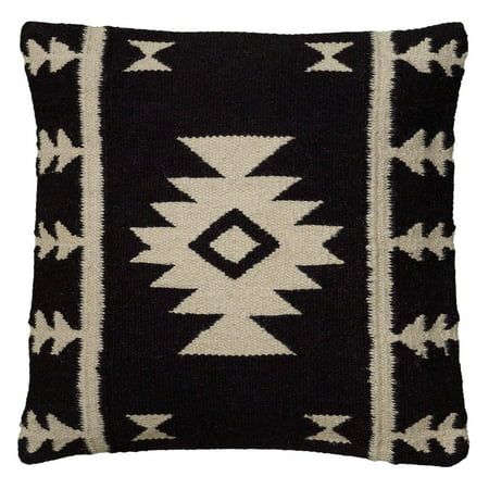 a black and white pillow with an arrow design on the front, sitting against a white background