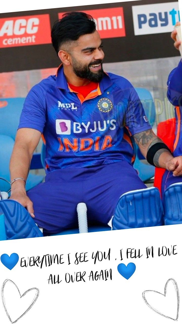 a man sitting on top of a chair wearing a blue shirt and pants with hearts drawn on it