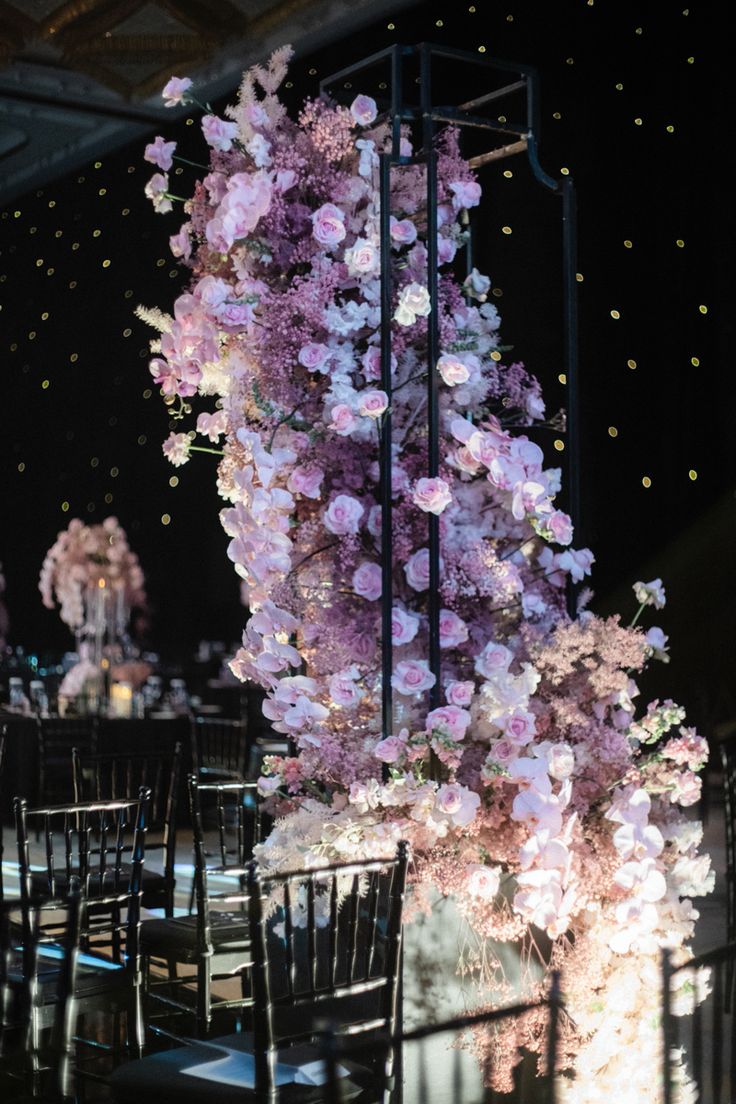 an arrangement of flowers and chairs at a wedding