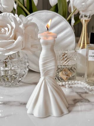 a white table topped with vases filled with flowers and candles