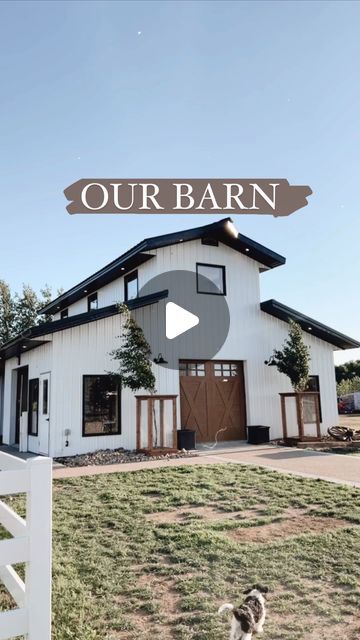 a dog standing in front of a white house with the words our barn on it