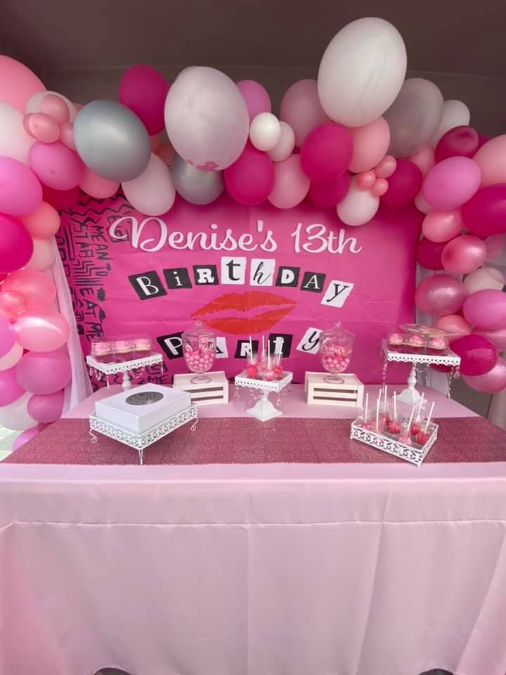 a pink and white birthday party with balloons