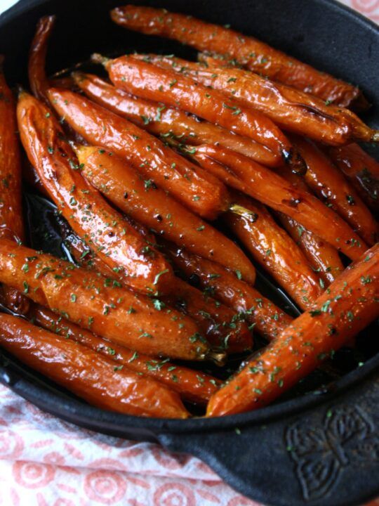 a pan filled with cooked carrots on top of a table