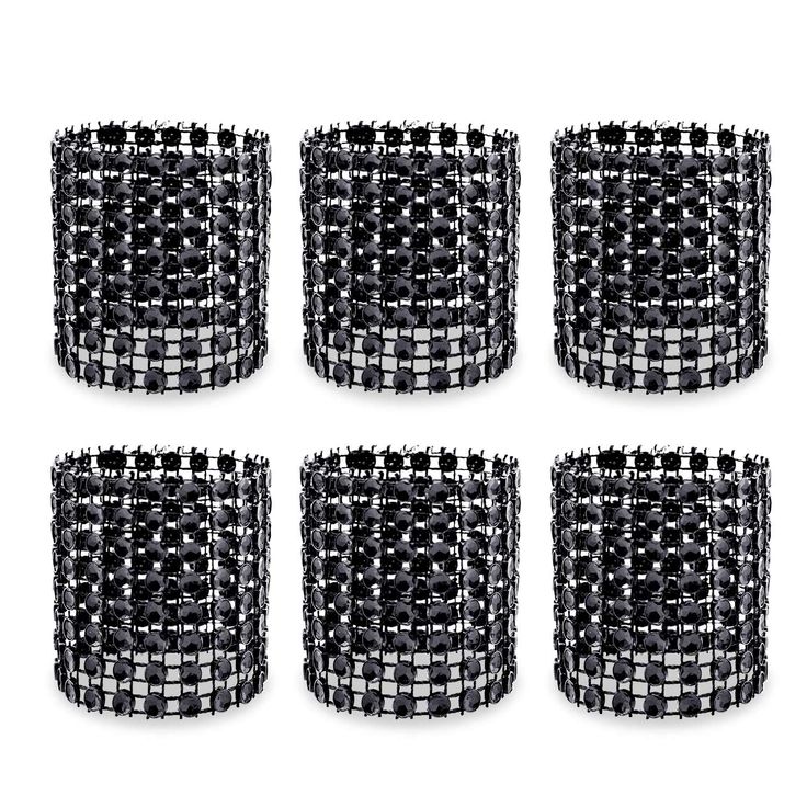 six black and white glass vases sitting next to each other