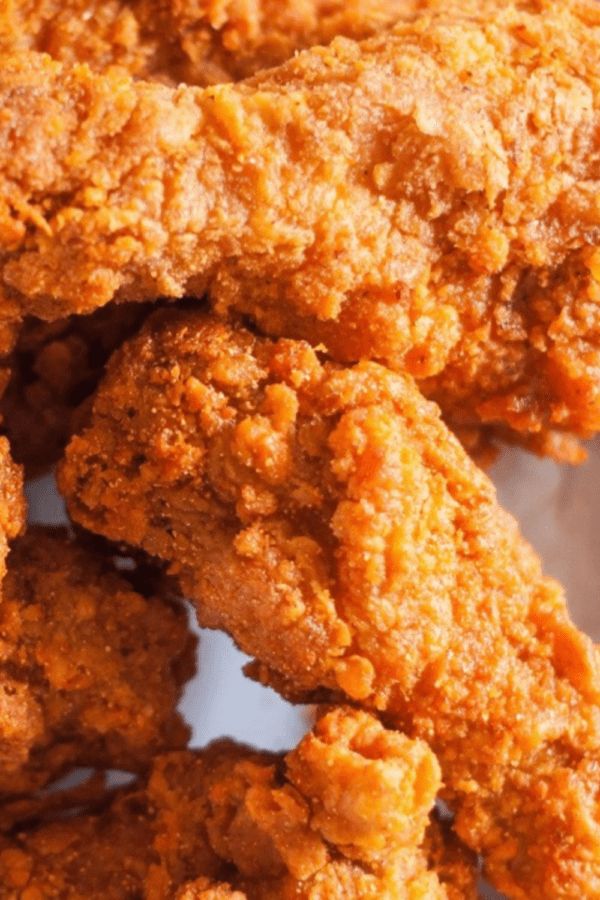 some fried food is sitting on a white paper wrapper and ready to be eaten