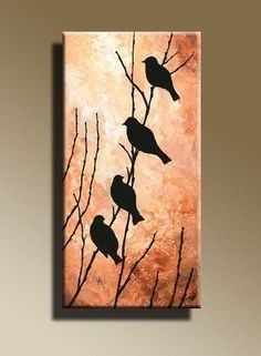 three birds sitting on top of a tree branch in front of a light brown frame