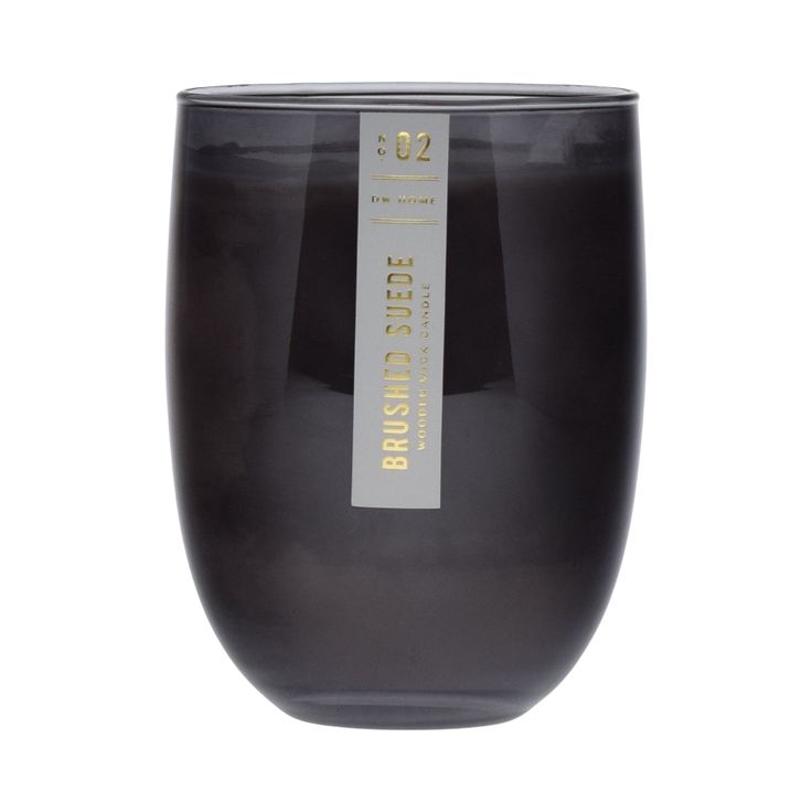 a black glass vase with a label on the front and bottom, sitting against a white background