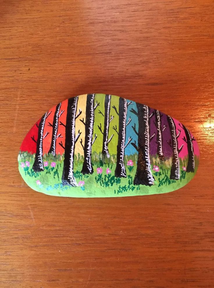 a painted rock sitting on top of a wooden table