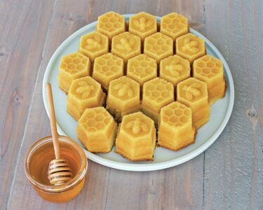 honeycomb lemon cake on a plate with honey in the background