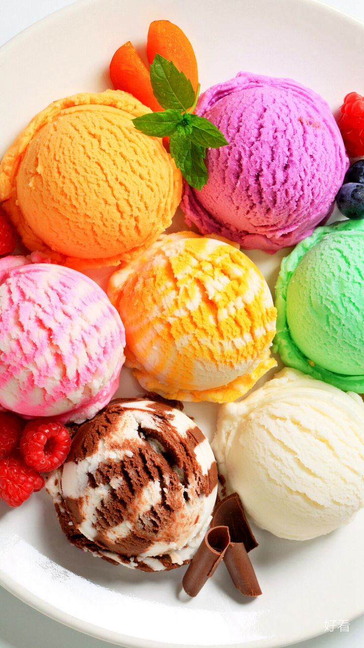 a white plate topped with different colored ice creams