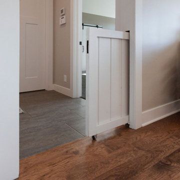 an open door leading into a room with hard wood flooring and white painted walls