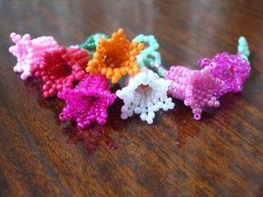 small crocheted flowers sitting on top of a wooden table