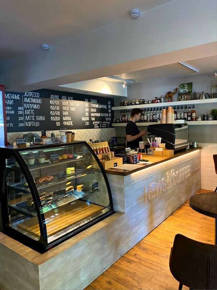 the inside of a deli filled with lots of food and people working behind the counter