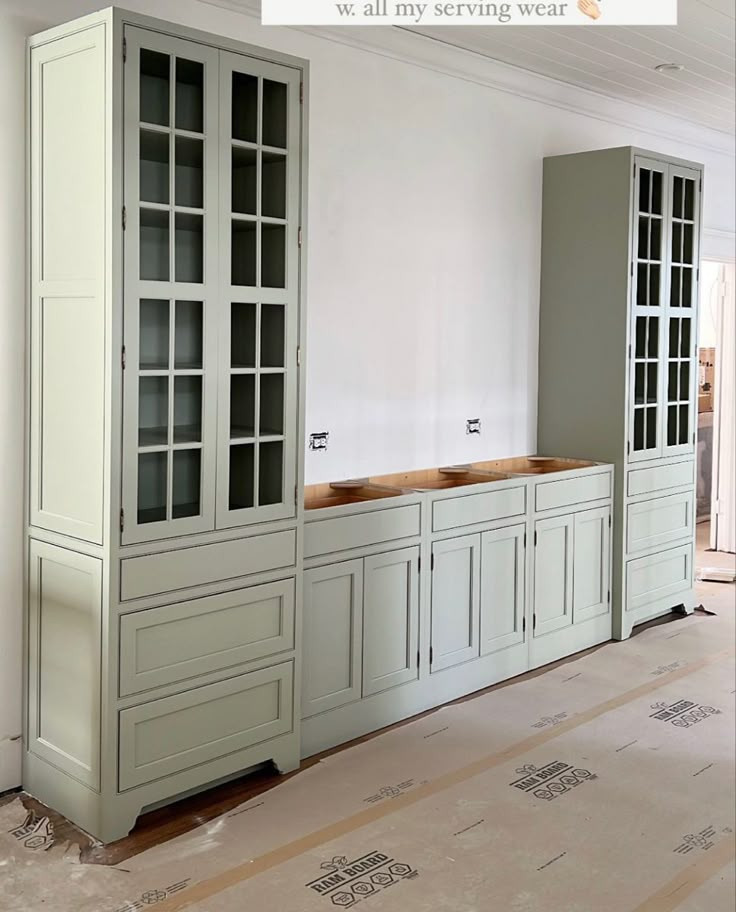 an empty room with white walls and cabinets in the process of remodeling