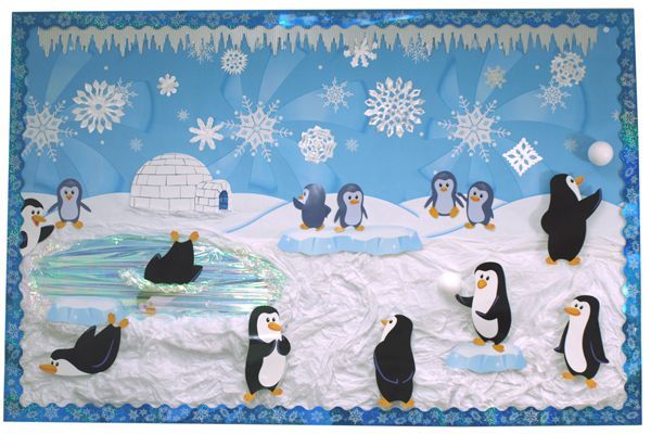 a group of penguins standing on top of snow covered ground