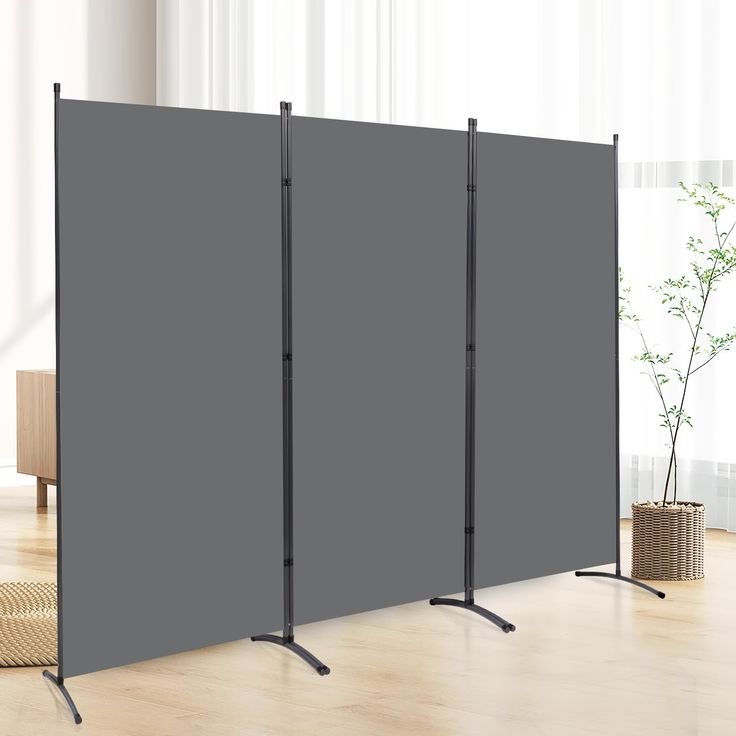 a room divider with three poles in front of it