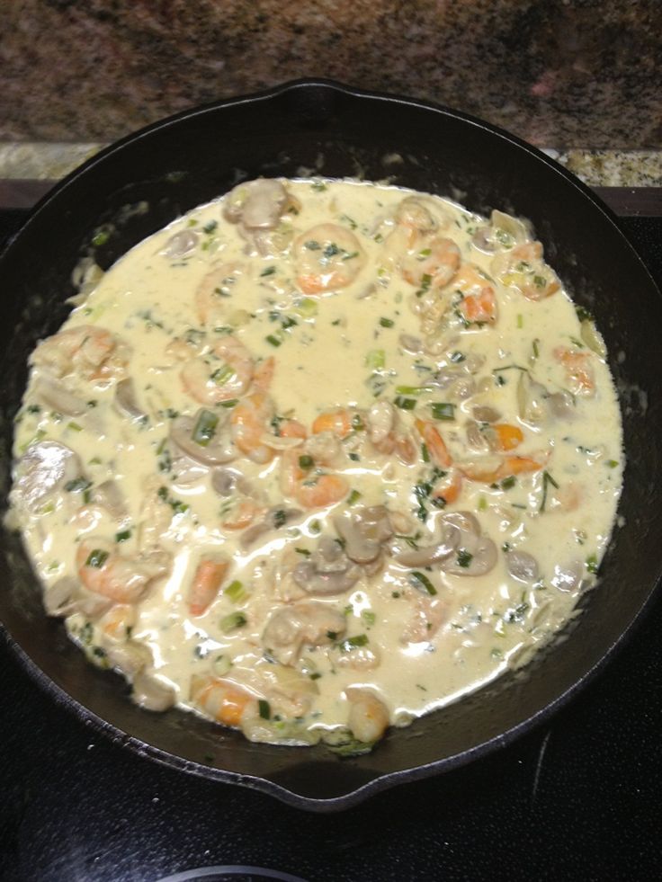 a skillet filled with food sitting on top of a stove