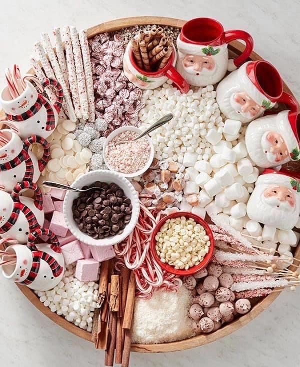 a platter filled with marshmallows, hot chocolate and other holiday treats