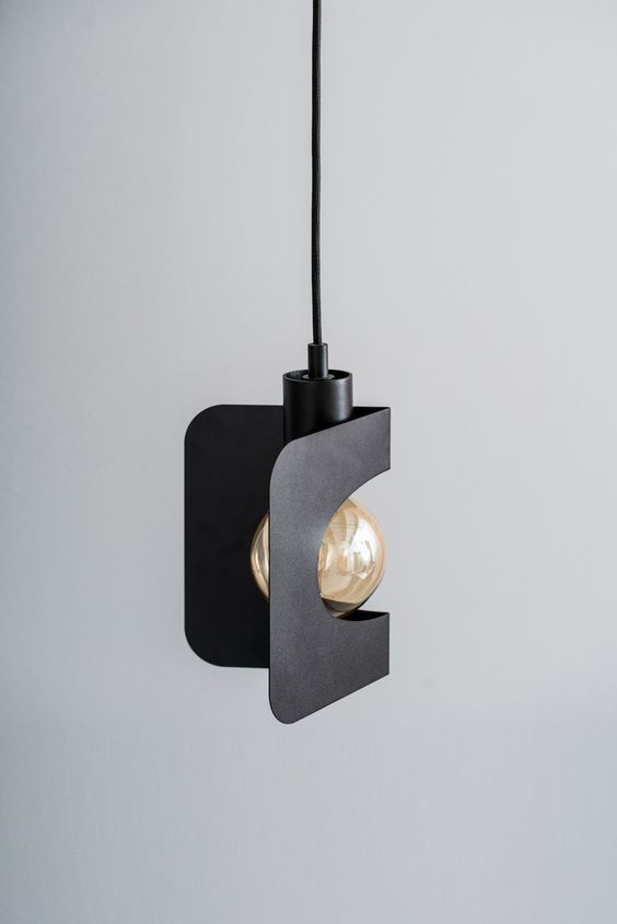 a black and white light hanging from a ceiling fixture with two lights on each side