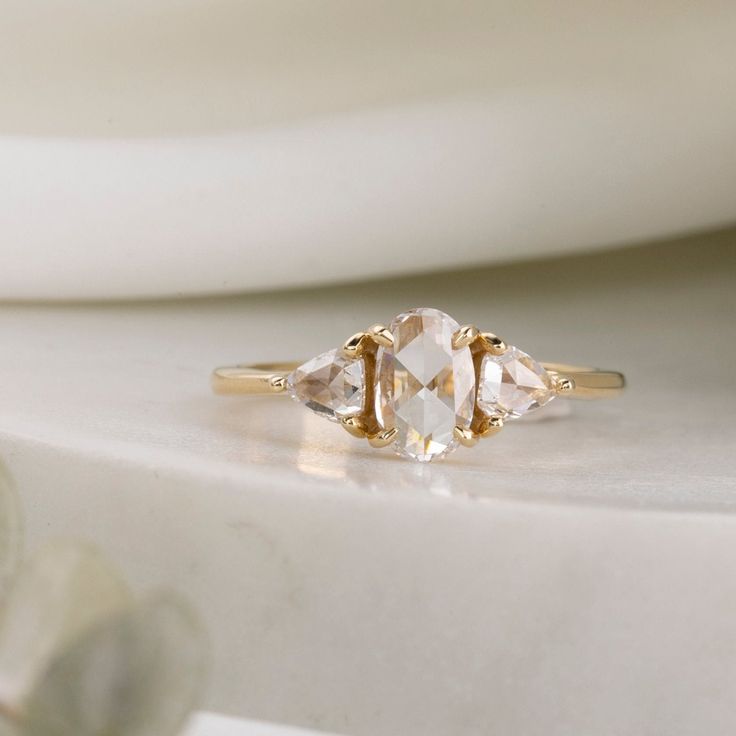 three stone ring sitting on top of a table