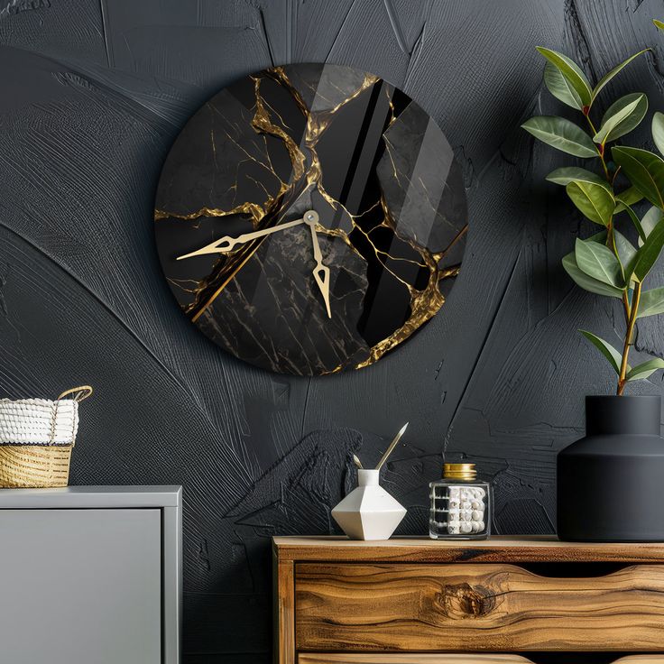 a black and gold clock sitting on top of a wall next to a wooden dresser