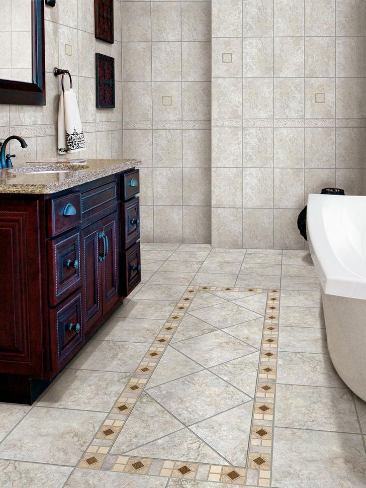 a bath room with a sink and a bath tub next to a mirror on the wall