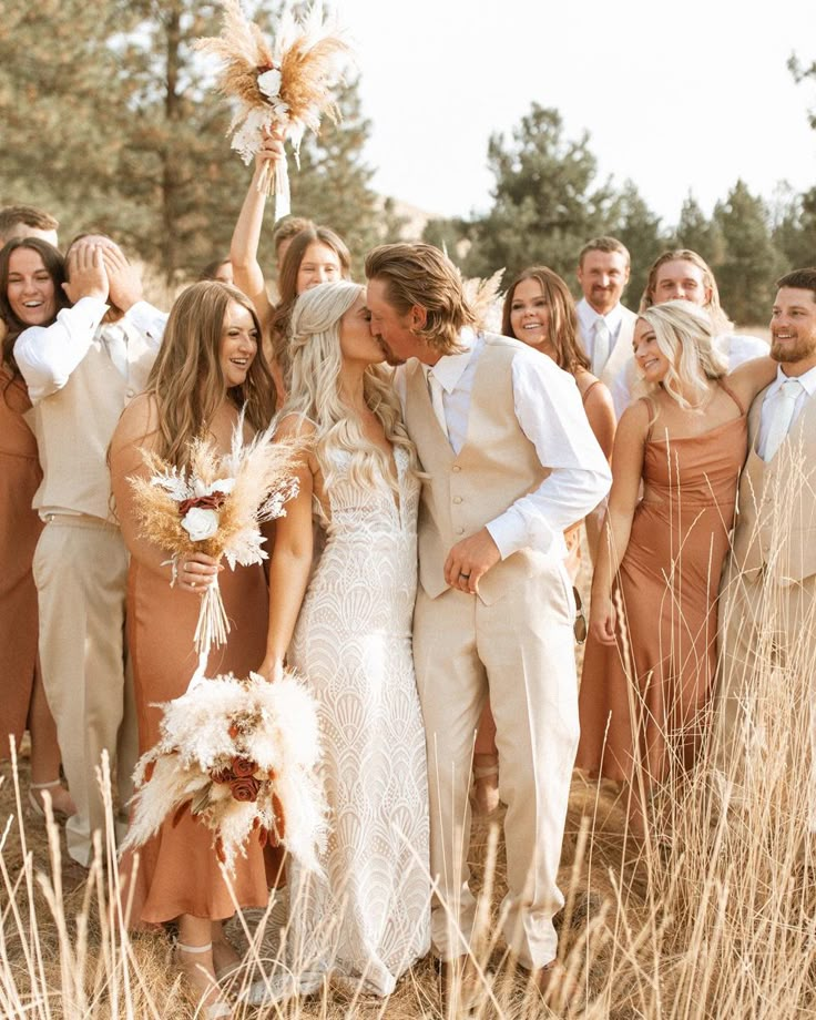 a group of people standing next to each other on top of a grass covered field