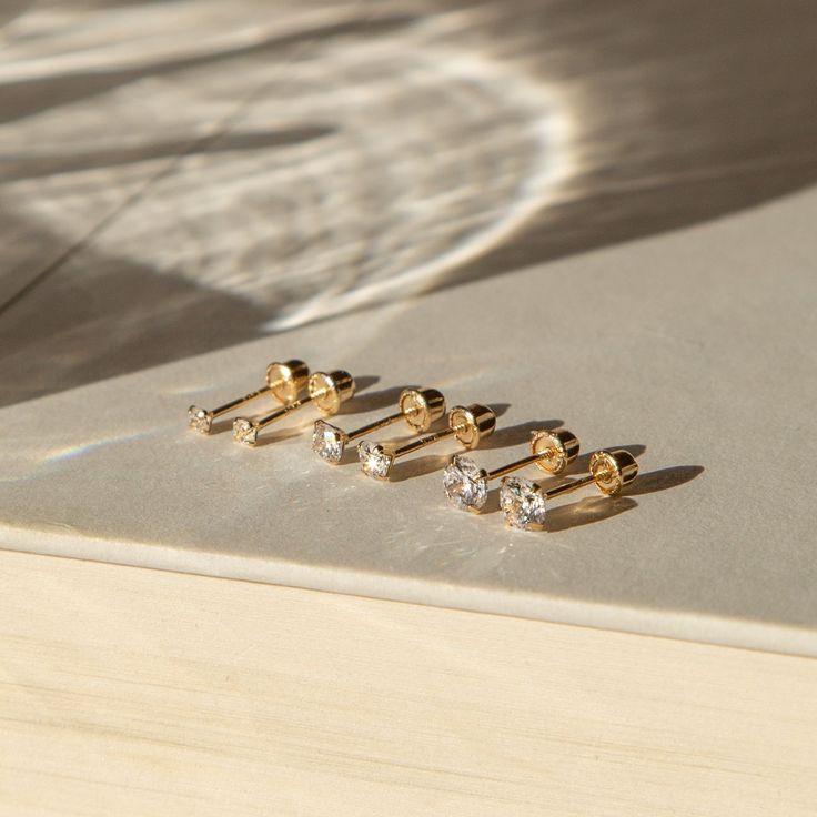 Sparkly and dainty, the Tiny CZ Screwback Stud Earrings are subtle yet stunning. They're so dainty and lightweight that you’ll forget they're even on. They have rounded screw backs so they're perfect for 24/7 wear without your head getting poked. Dress them up or down - either way, they'll instantly make you feel more confident and put together! Made of solid gold, they are ready for years of little dates and big adventures together. DETAILS 14k solid gold screwback studs Available in 2mm, 3mm, Stud Aesthetic, Jewelry Shoot, Feel More Confident, Mini Studs, Gold Aesthetic, Gold Earrings Studs, Gold Studs, Real Gold, Aesthetic Pictures