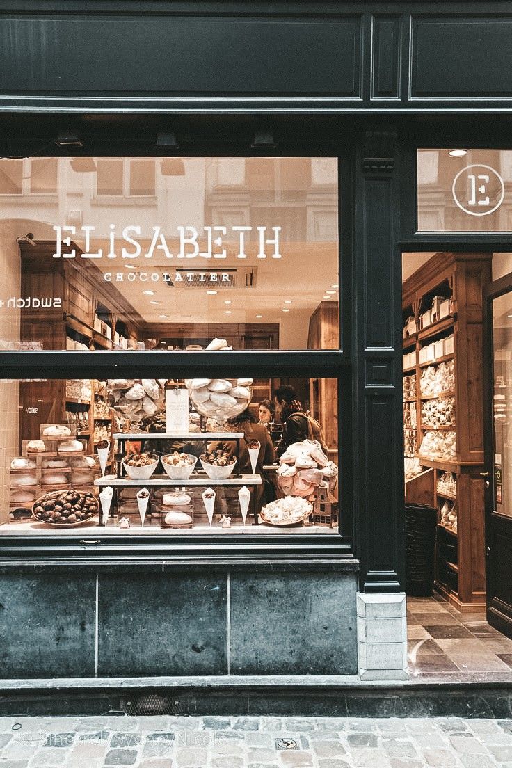 a store front with an assortment of pastries in the window