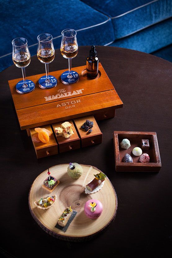 a table topped with different types of desserts and wine glasses on top of it