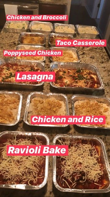 many trays of food that include lasagna, chicken and rice