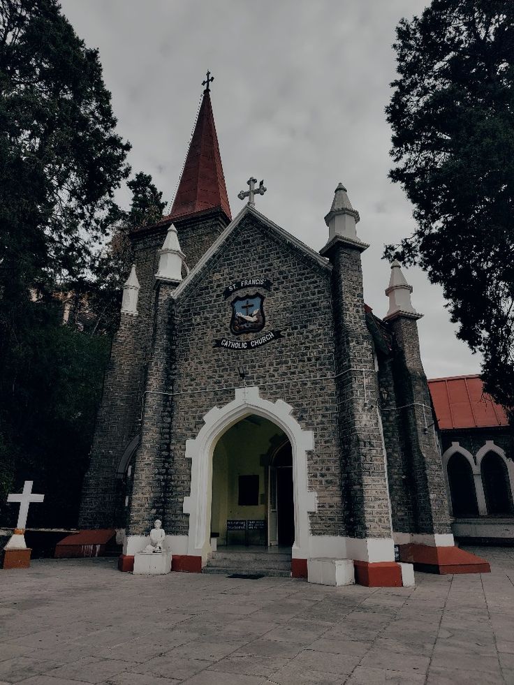 an old church with a cross on the front