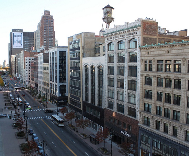 the city street is lined with tall buildings