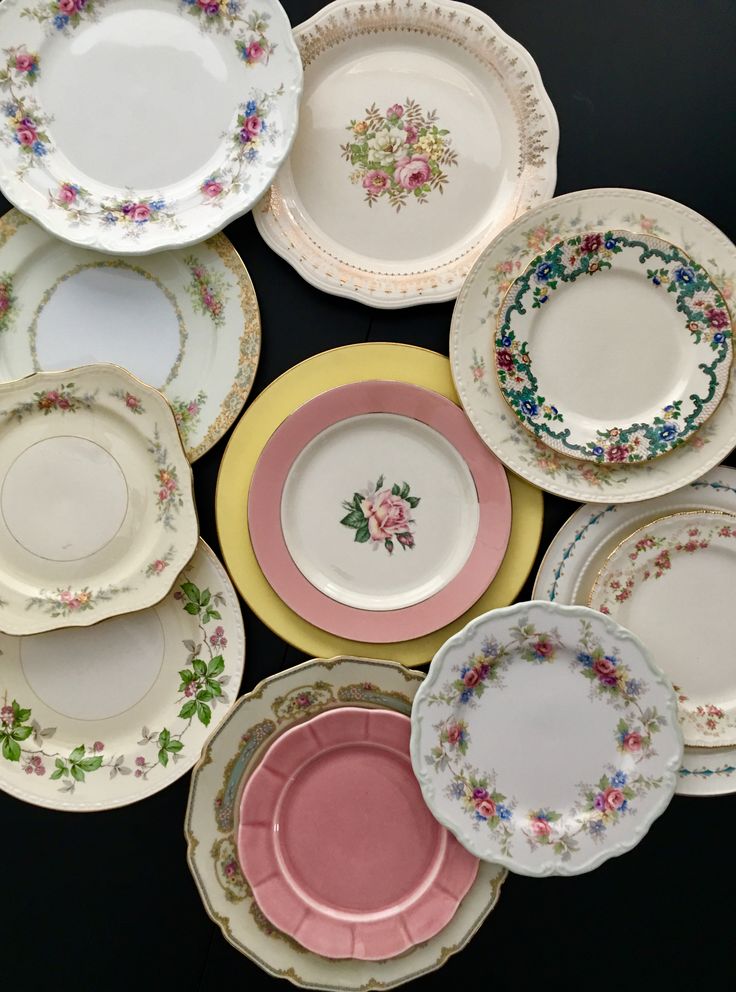 a collection of porcelain plates with flowers on them