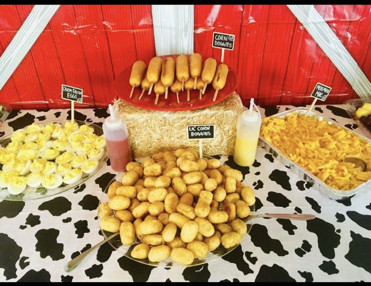 a table topped with lots of different types of food next to each other on top of a cow print table cloth