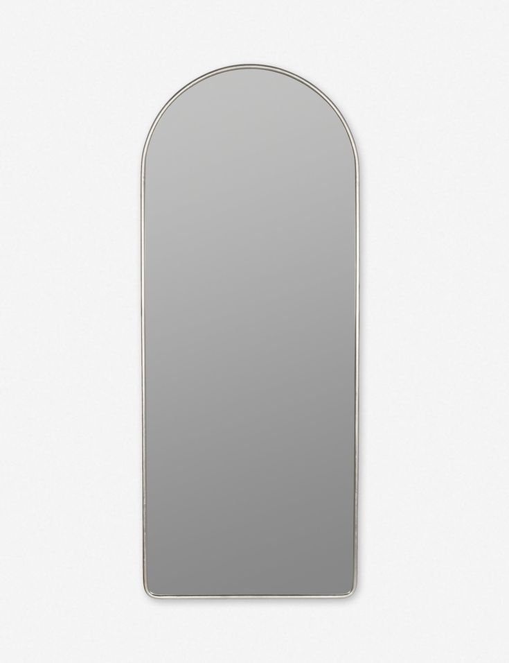 an arched mirror is shown against a white wall