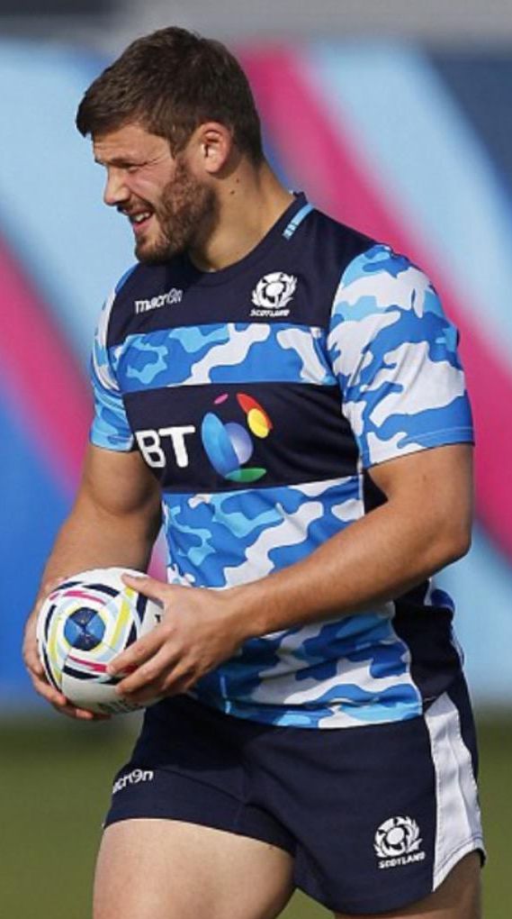 a man holding a soccer ball on top of a field