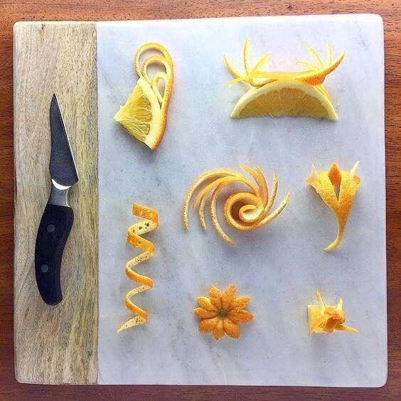 orange peels cut up and placed on a cutting board next to a pair of scissors